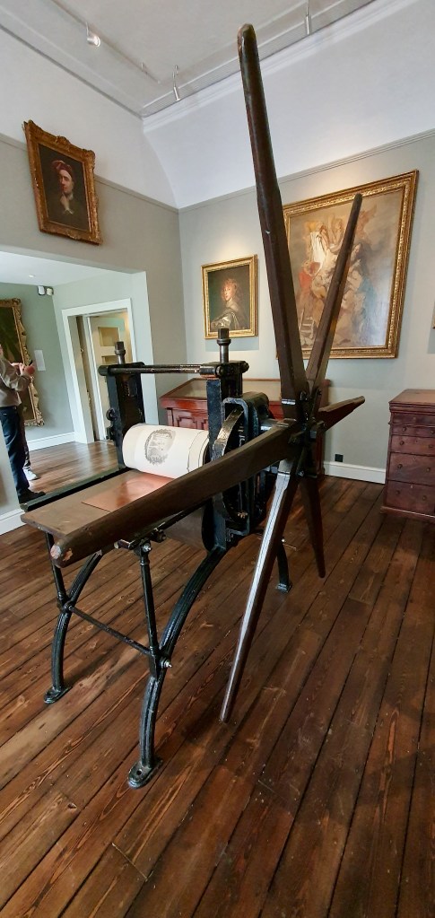 "Giant star printer with copper etching pad and rolled picture on it."