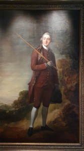 "Georgian gentlemen in fine red clothes, long white sock carring stick."